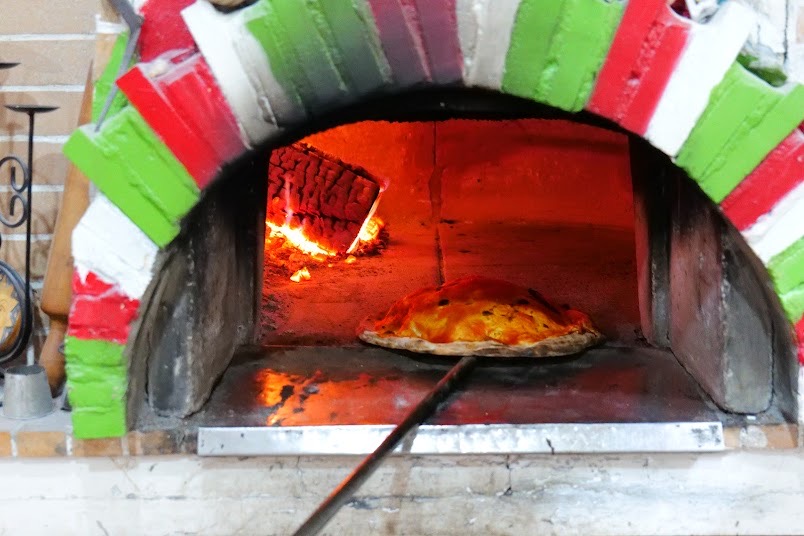 The Italian-flag painted wood-fired pizza oven